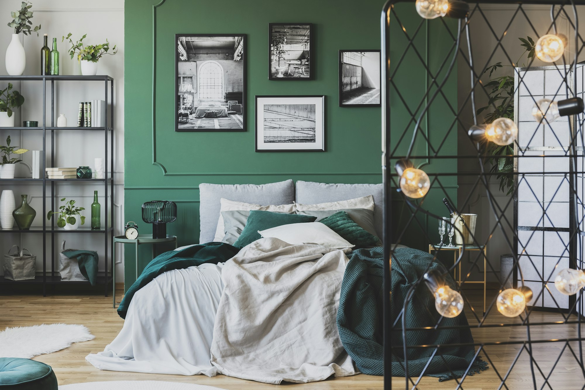 Cozy bed with pillows and blankets in emerald and grey colors